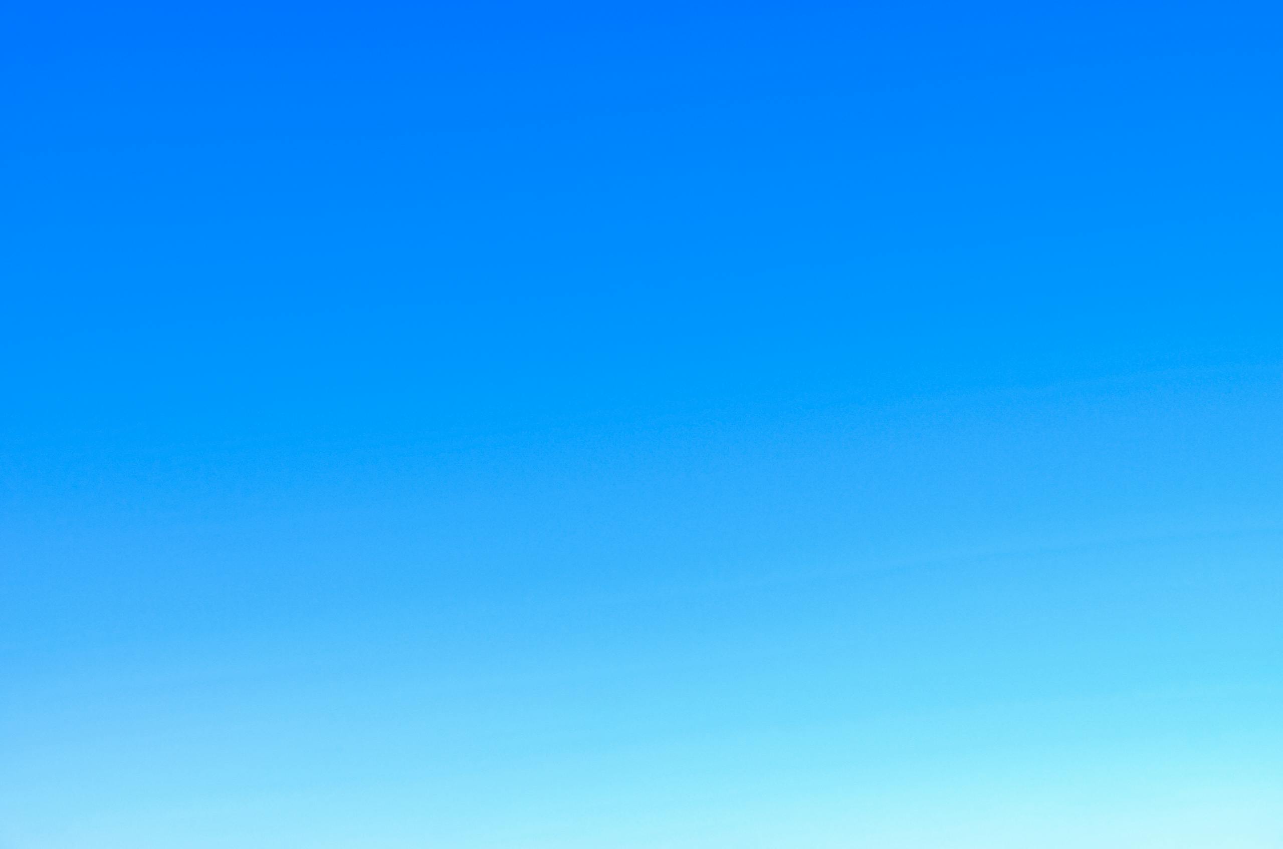 Permanentad A serene view of a vibrant clear blue sky with a subtle gradient, perfect for backgrounds.