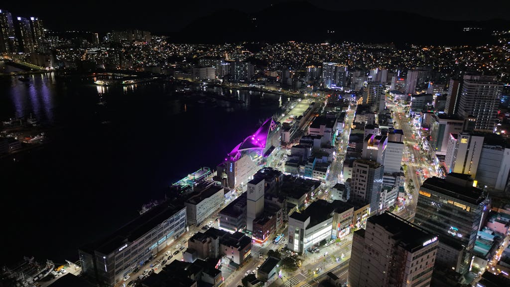 Eagles Rookie Trade Attempt A stunning aerial shot capturing the vibrant city lights of Busan at night, showcasing urban architecture.