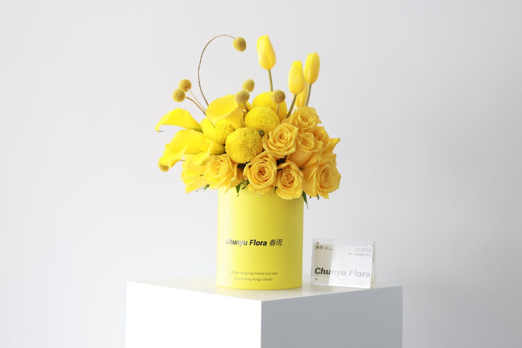Shop Spring Vase Bright bouquet of yellow roses and tulips in stylish vase, perfect for spring decor.