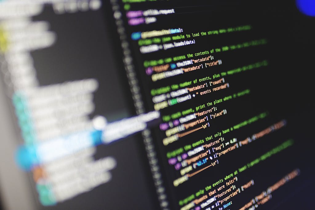 630 Area Code Close-up of a computer screen displaying colorful programming code in JavaScript.