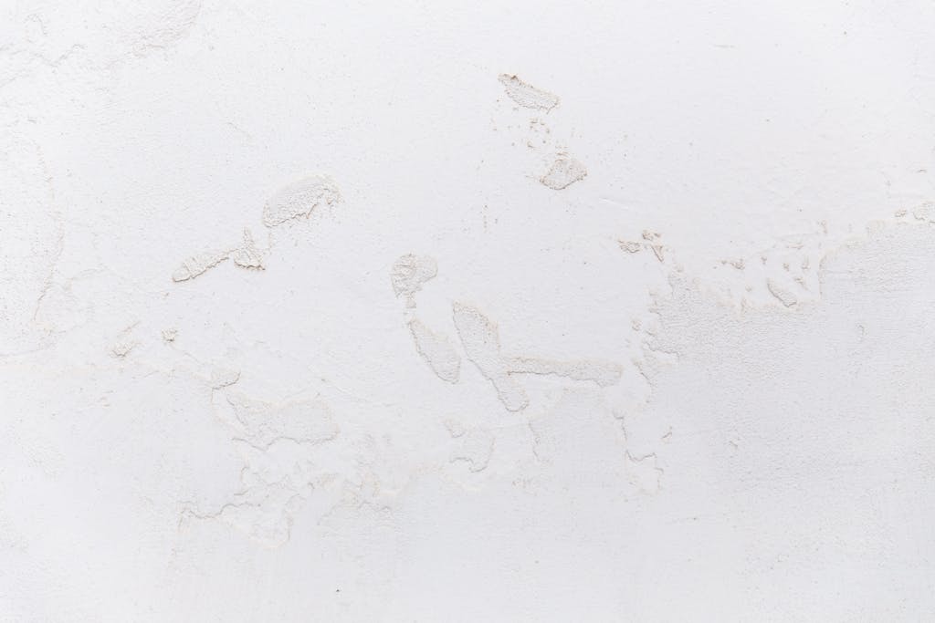 Emfyteymata Close-up of a textured white stucco wall, ideal for design and decor projects.