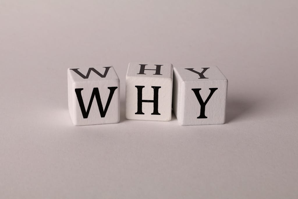 ChatPic Close-up of lettered dice spelling 'WHY' on a neutral background, ideal for concepts of inquiry or curiosity.