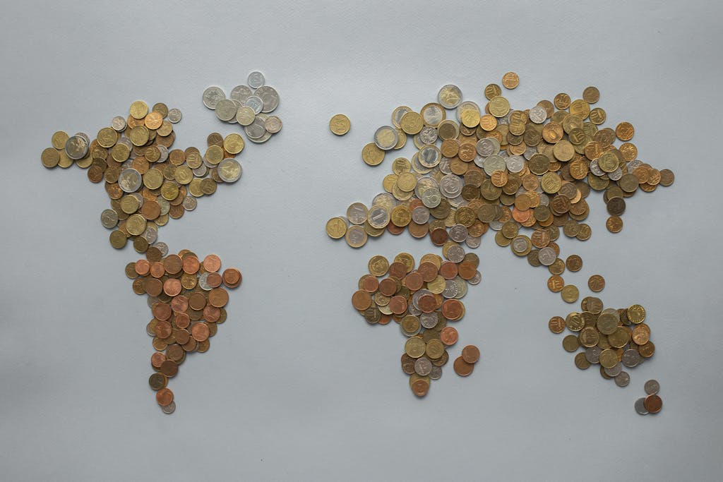 theglobeandmail.com.mx Creative world map made from assorted coins on a solid gray backdrop, symbolizing global finance.