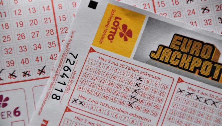 Florida Woman Wins Monopoly Lottery Detailed close-up of a EuroJackpot lottery ticket with selected numbers in focus.