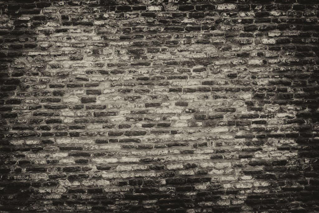 Permanentad Grayscale textured brick wall background with rough surface.