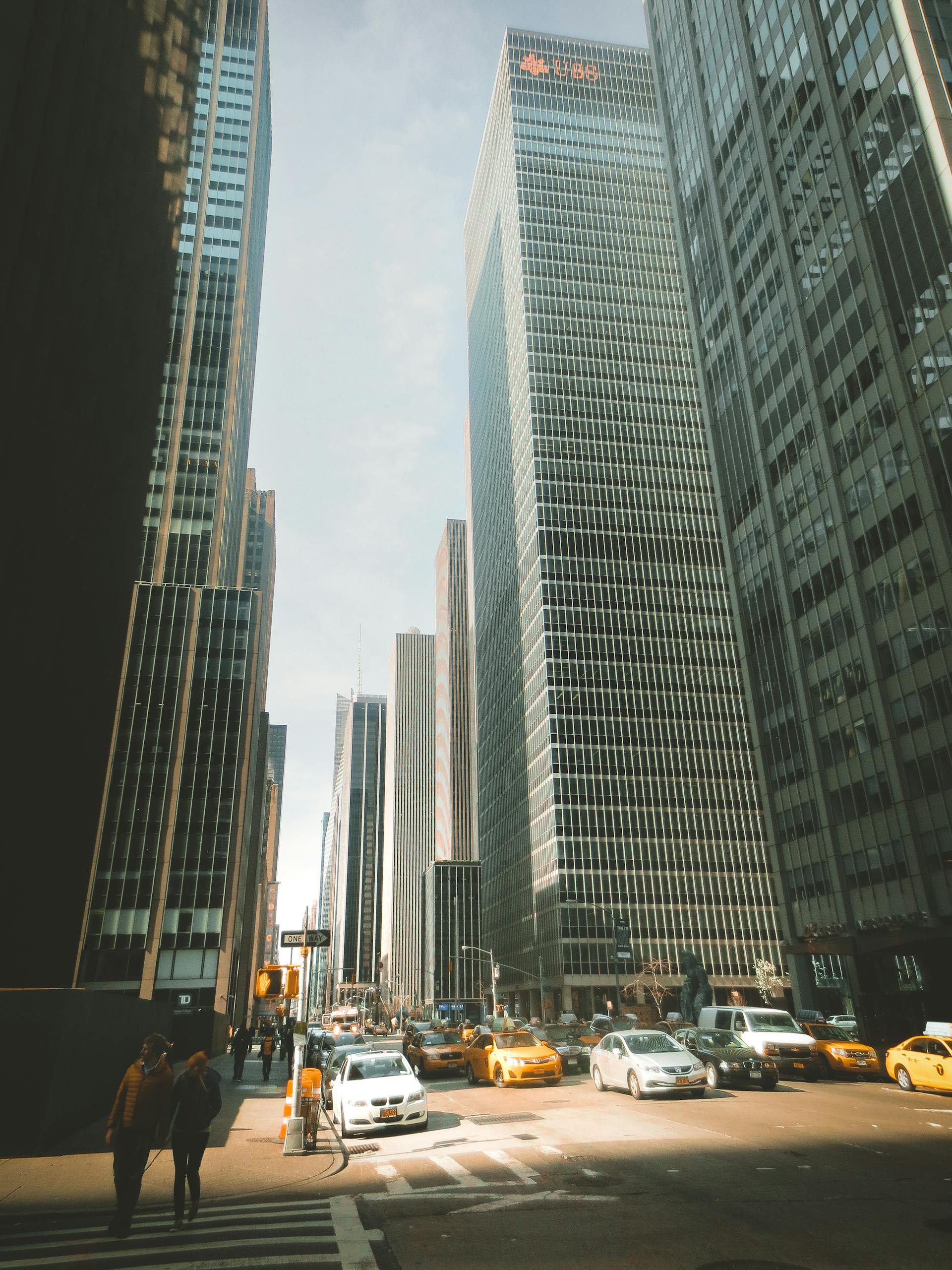The Rise of the SocialMediaGirl Iconic New York street scene with towering skyscrapers and busy traffic under clear skies.