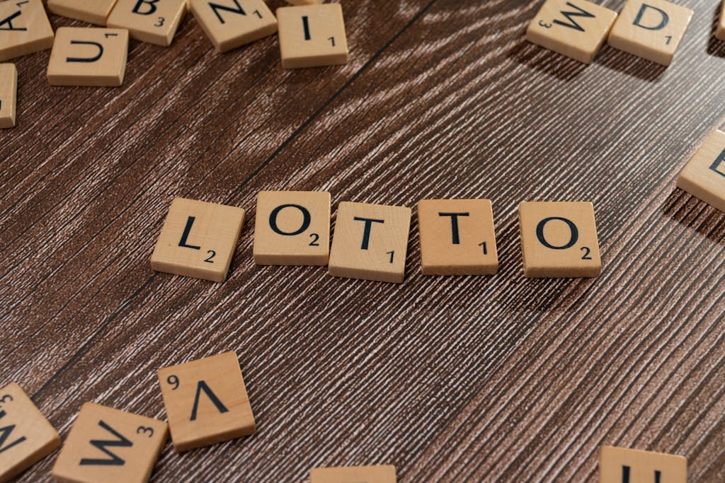 Florida Woman Wins Monopoly Lottery  Scrabble tiles spelling 'LOTTO' on a wooden table surface, symbolizing chance and gaming.