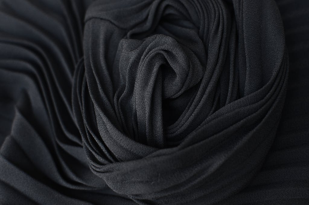 HerbCiepScam Top view abstract textured background of dark gray pleated textile placed on table