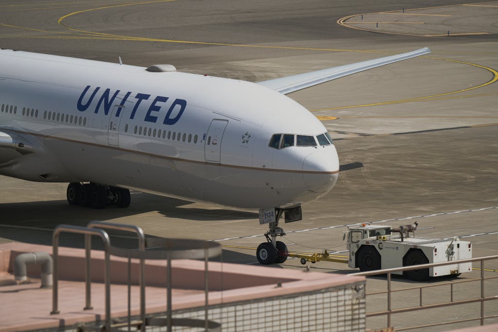 United Flight UA109 Diversion United Airlines aircraft being towed on the runway at Taoyuan City Airport, Taiwan.