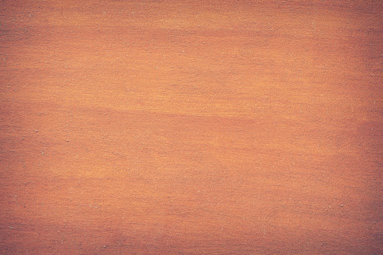 Voozon Vibrant orange textured surface, perfect for design backdrops and creative projects.