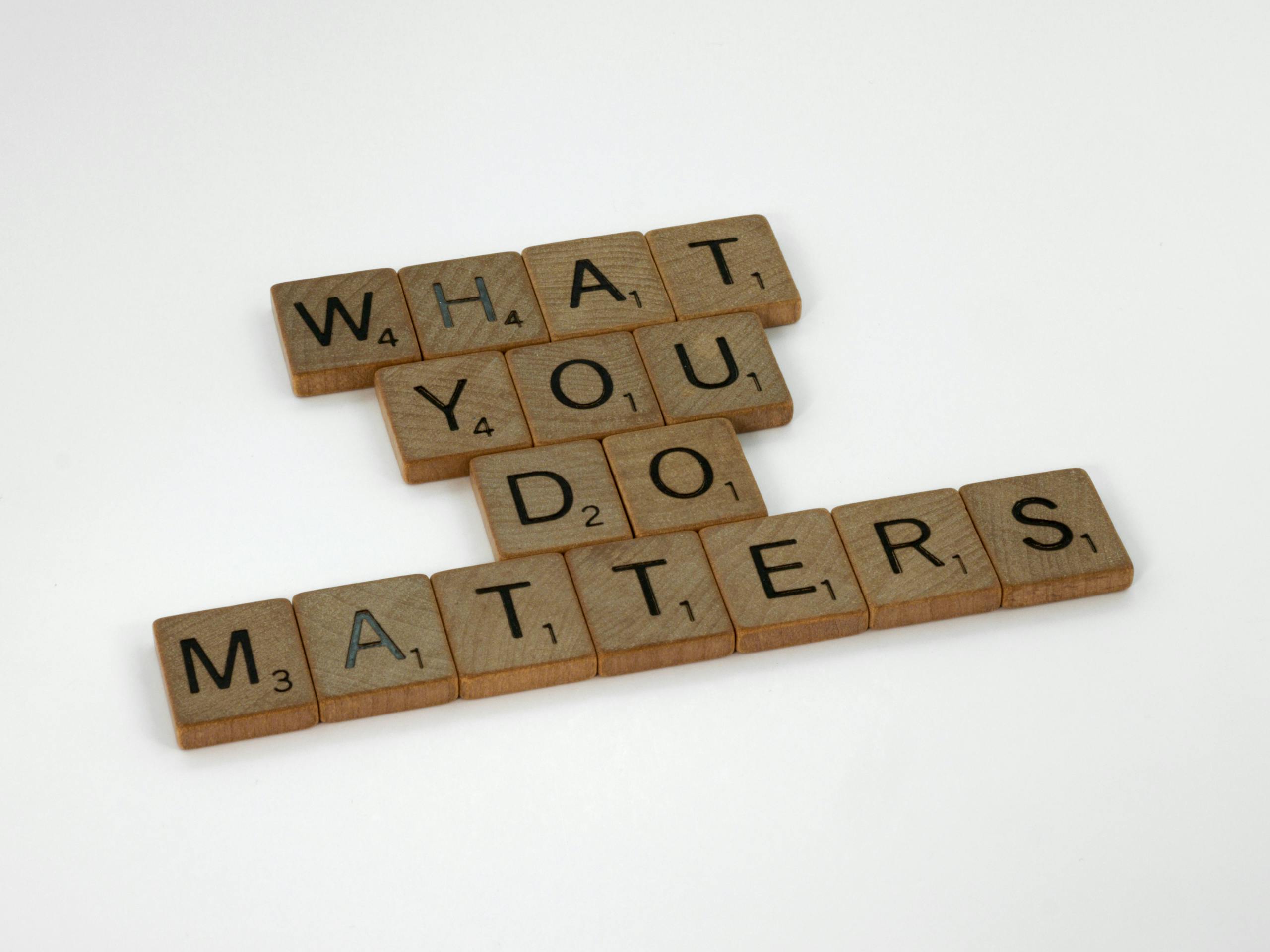 ChatPic Wooden letter tiles spelling 'What You Do Matters' on a neutral background.